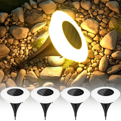 Lampe solaire extérieur sur pied avec lumière chaude installée dans des cailloux
